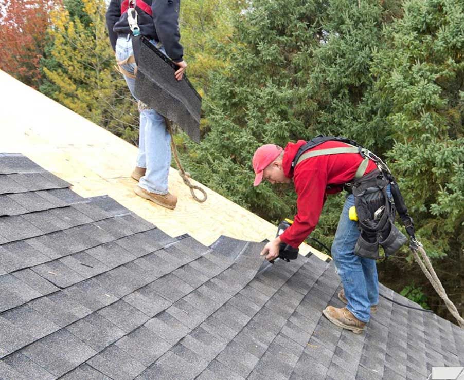 JS Exteriors workers installing a roof
