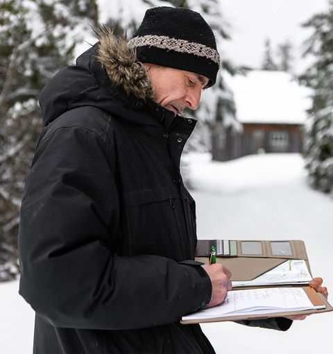 JS Exteriors inspector taking notes after a hail storm