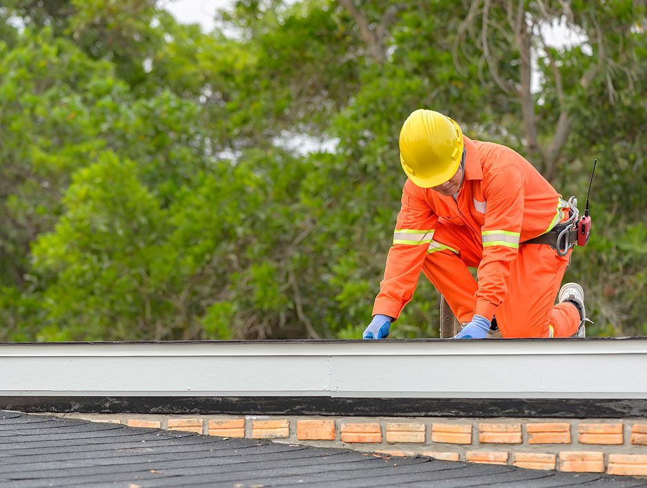JS Exteriors worker on a commercial roof project