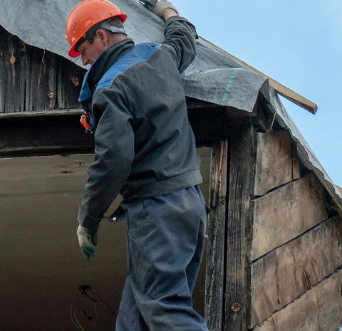 JS Exteriors technician on a roof in cold weather