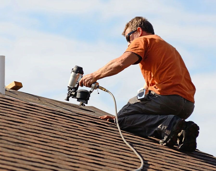 JS Exteriors roofer installing GAF shingles