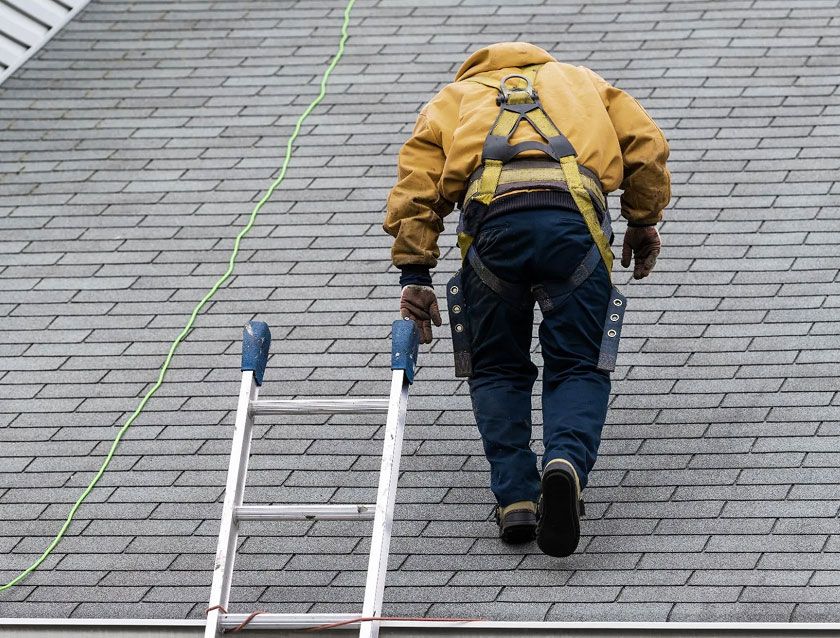 JS Exteriors technician performing an emergency roof repair