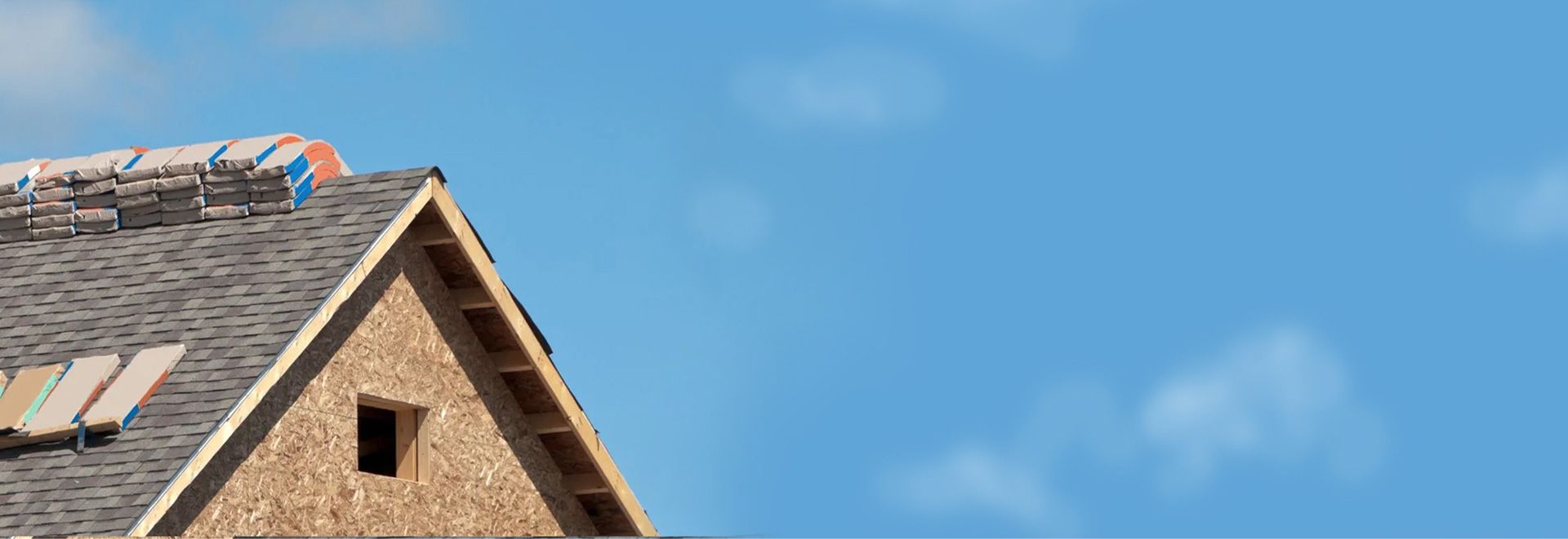 Roof under emergency repair against a clear blue sky