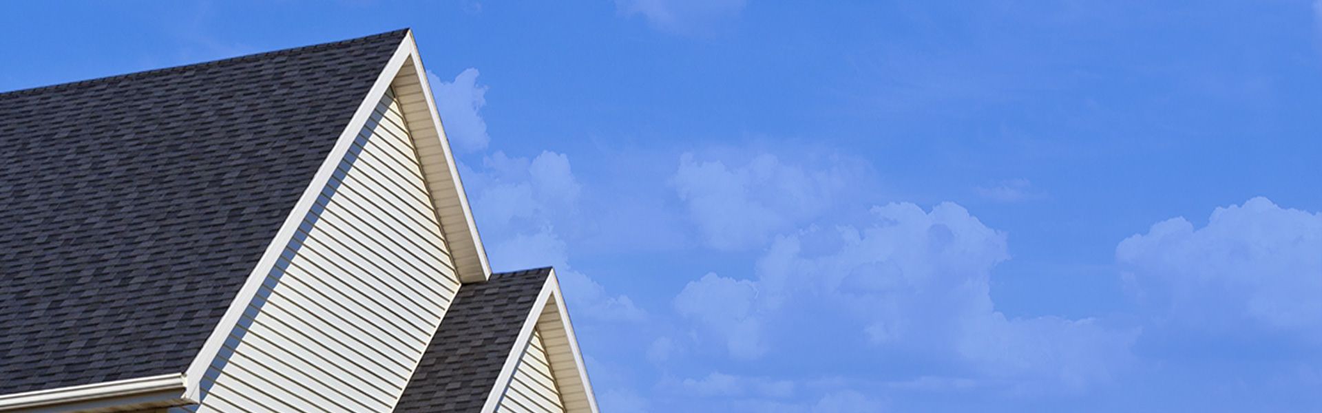 A home featuring fresh siding against a blue sky