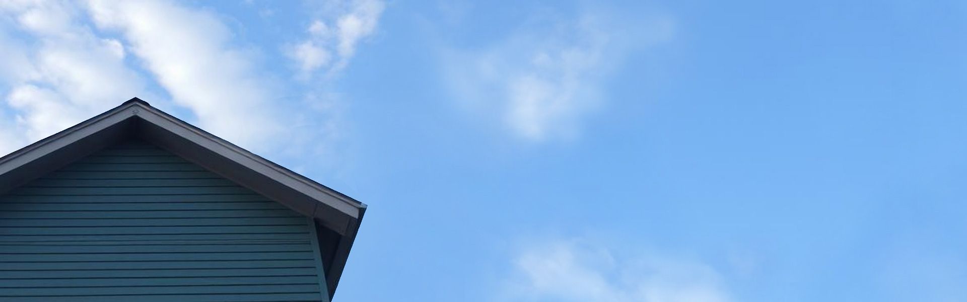 A home with newly installed siding against a blue sky